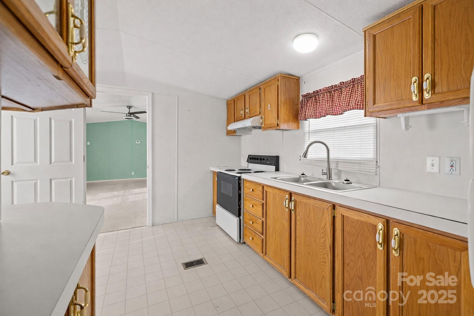 2909 New Town Road Monroe, NC 28110 - Photo 10 of 31 a kitchen with sink a refrigerator and cabinets
