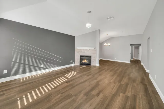 a view of an empty room and wooden floor