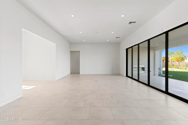 a large living room with stainless steel appliances kitchen island granite countertop a sink and cabinets