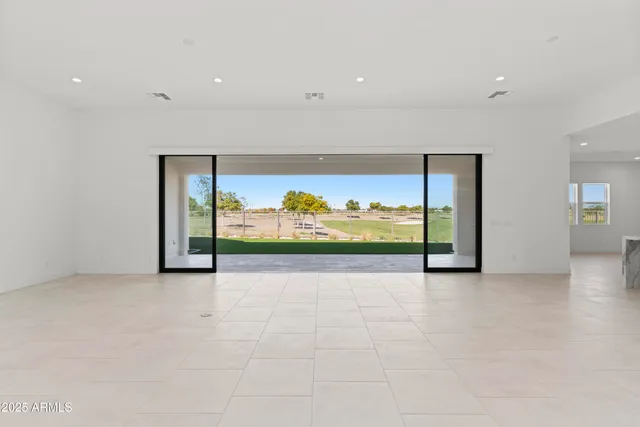 a large kitchen with stainless steel appliances lots of counter space and wooden floor