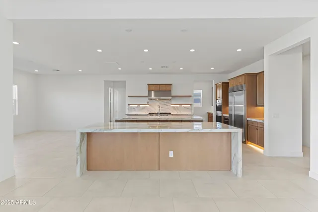 a kitchen with stainless steel appliances granite countertop a sink and stove
