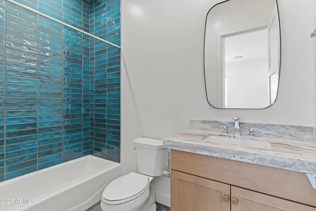 a living room with furniture a fireplace and a large window