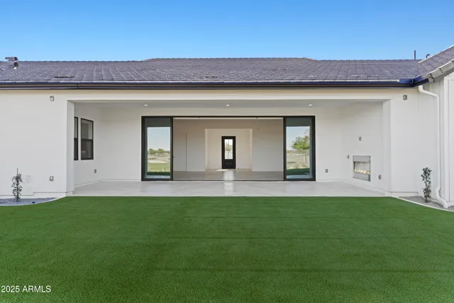 a view of empty room with wooden floor and windows