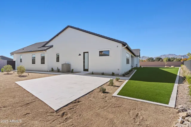 a view of a terrace with furniture and a garden