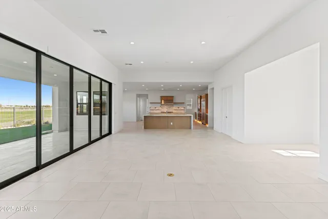 a large kitchen with stainless steel appliances a large counter top