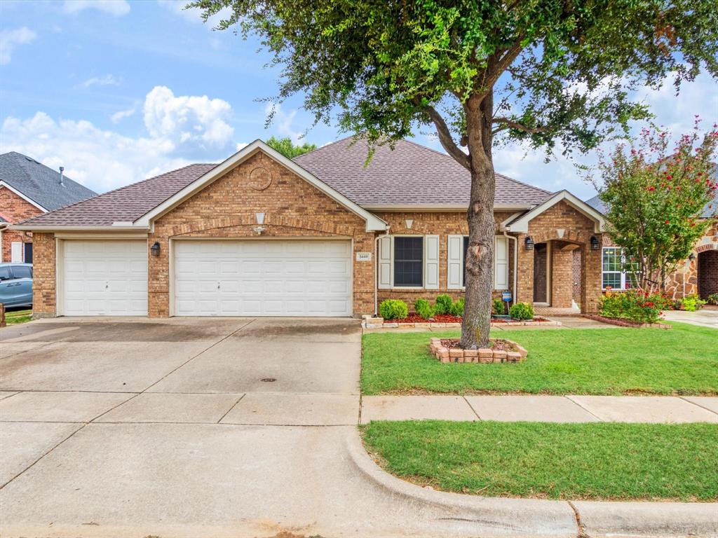 5440 Lavaca Road Grand Prairie, TX 75052 - Photo 3 of 22 Brick exterior with a shingled roof, two-car garage, and a concrete driveway
