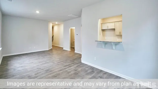 a view of a room with wooden floor and window