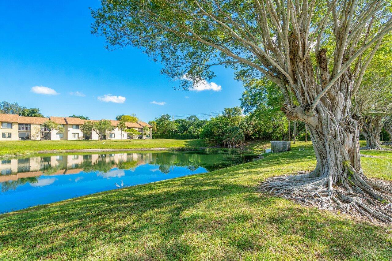 6736 Palmetto Circle South, Unit 105 Boca Raton, FL 33433 - Photo 1 of 28 a view of an outdoor space and a lake view