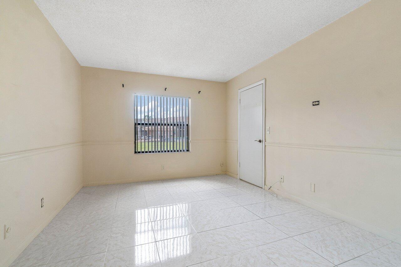 6736 Palmetto Circle South, Unit 105 Boca Raton, FL 33433 - Photo 15 of 28 a view of an empty room with a window