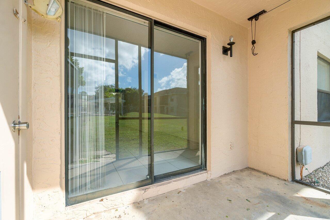 6736 Palmetto Circle South, Unit 105 Boca Raton, FL 33433 - Photo 21 of 28 a bathroom with a glass shower door