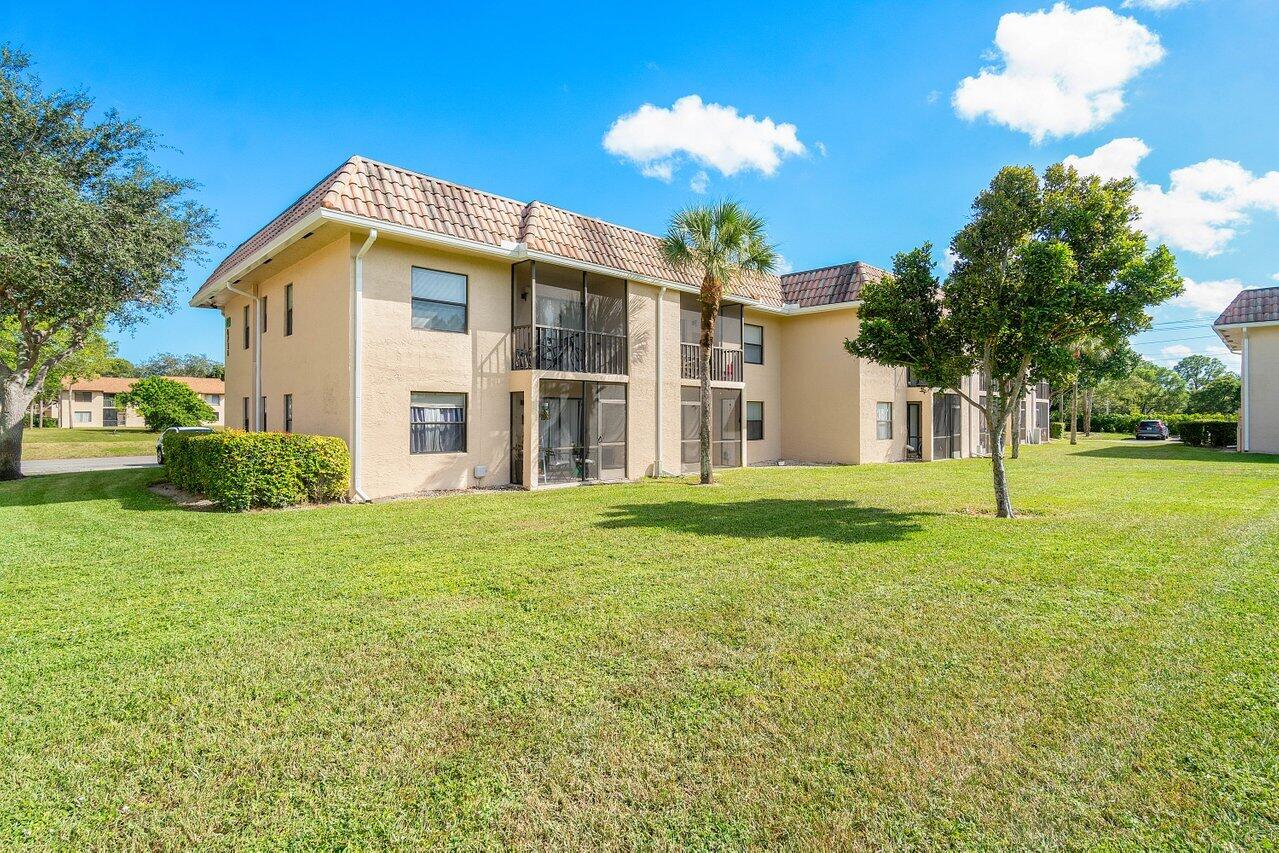 6736 Palmetto Circle South, Unit 105 Boca Raton, FL 33433 - Photo 24 of 28 a view of a house with a backyard