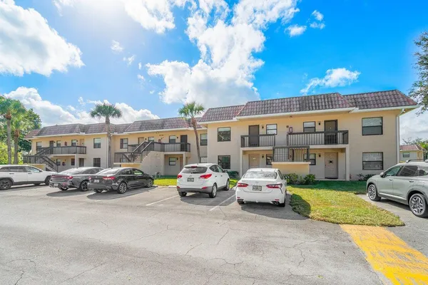 a view of a house with swimming pool and sitting area