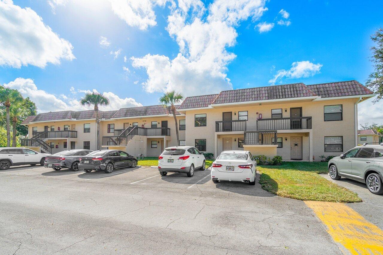6736 Palmetto Circle South, Unit 105 Boca Raton, FL 33433 - Photo 26 of 28 a cars parked in front of a building