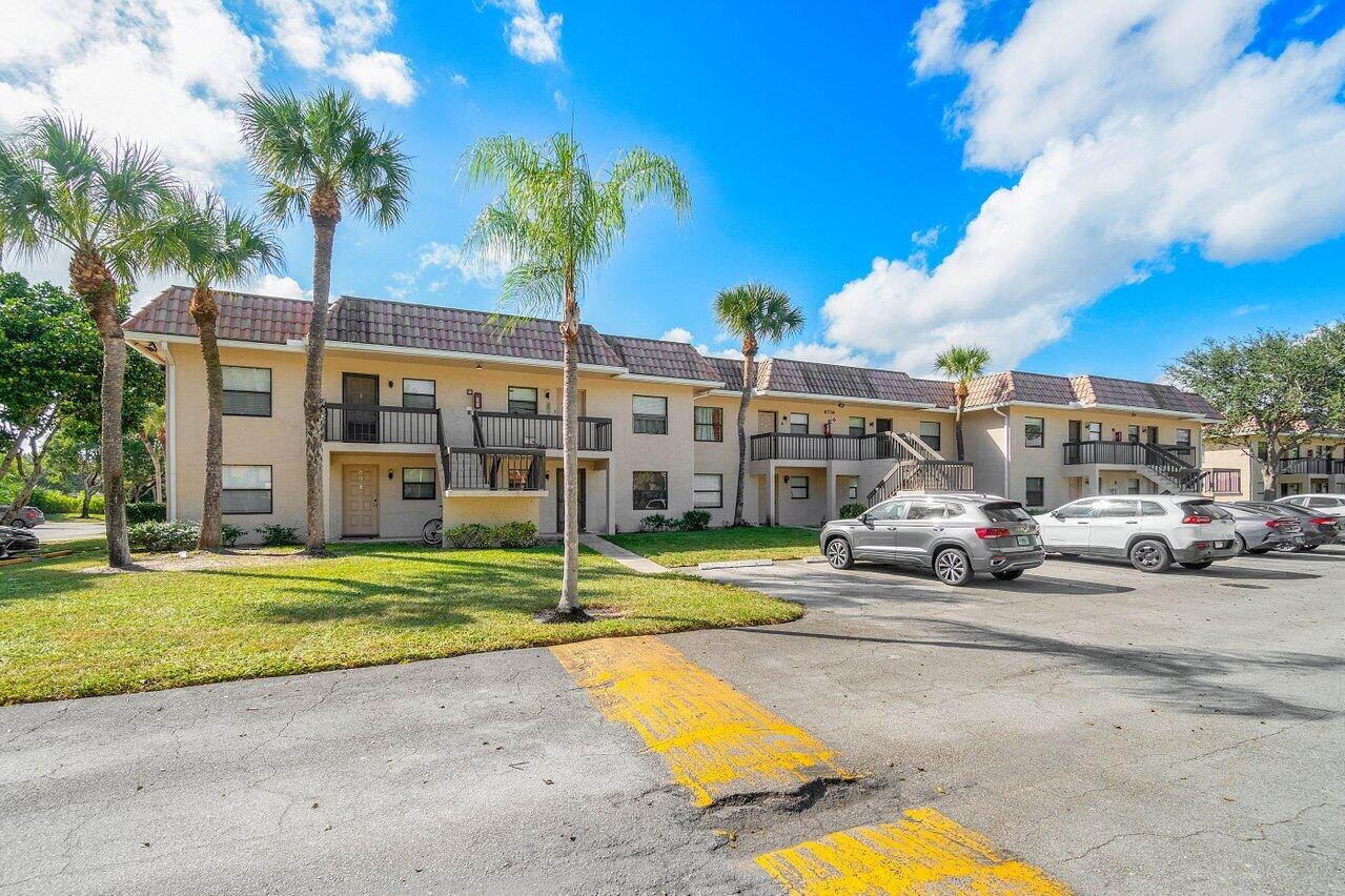 6736 Palmetto Circle South, Unit 105 Boca Raton, FL 33433 - Photo 28 of 28 a view of a car park in front of house