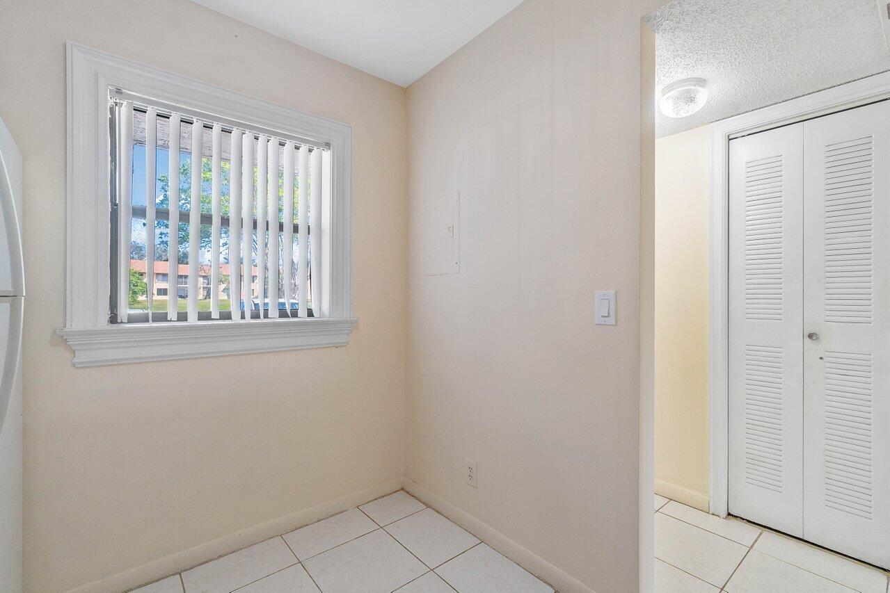 6736 Palmetto Circle South, Unit 105 Boca Raton, FL 33433 - Photo 5 of 28 a view of an empty room with a window