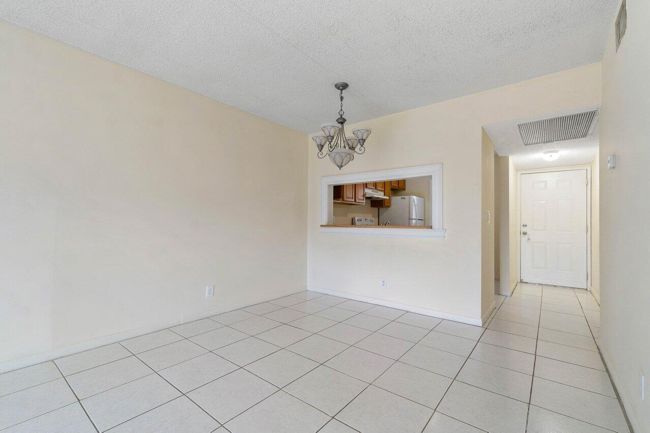 6736 Palmetto Circle South, Unit 105 Boca Raton, FL 33433 - Photo 8 of 28 an empty room with a hallway