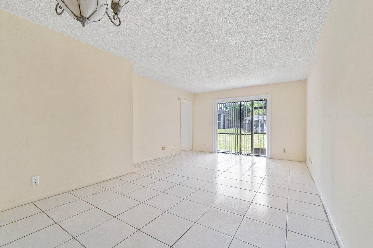 6736 Palmetto Circle South, Unit 105 Boca Raton, FL 33433 - Photo 10 of 28 a view of an empty room and window