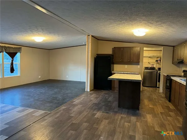 a large kitchen with a sink and stainless steel appliances