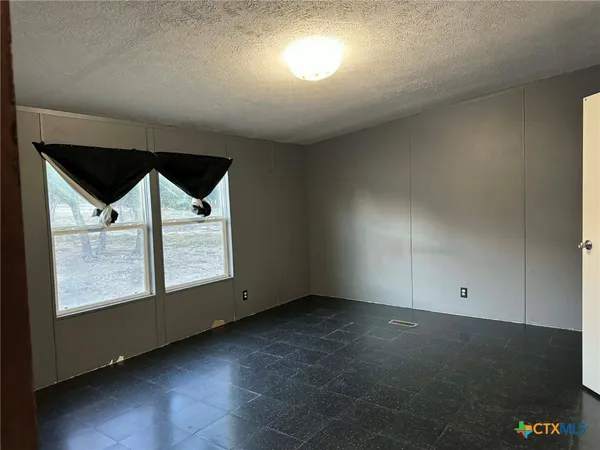 an empty room with a empty space and windows