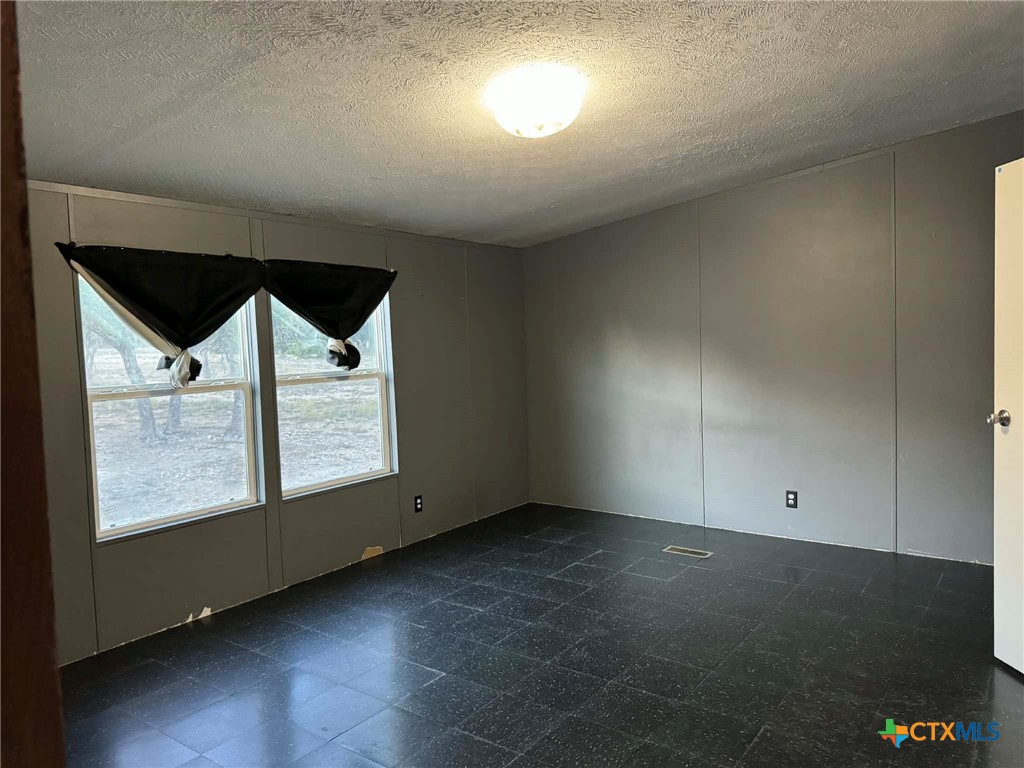 Undisclosed Address Kempner, TX 76539 - Photo 9 of 29 an empty room with a empty space and windows