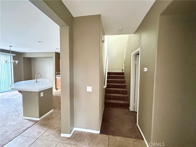a view of a hallway view with wooden floor and staircase