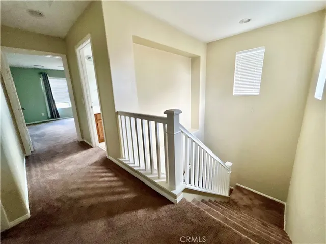 a view of a hallway with staircase