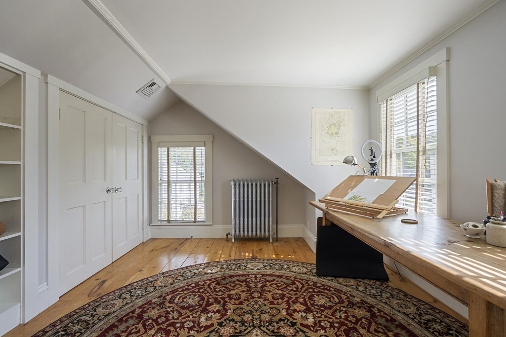 49 Parker Street Lexington, MA 02421 - Photo 20 of 42 a room that has a couch and a stove in it