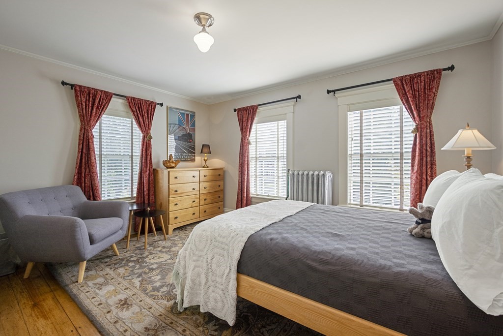 49 Parker Street Lexington, MA 02421 - Photo 22 of 42 a bedroom with a bed and wooden floor