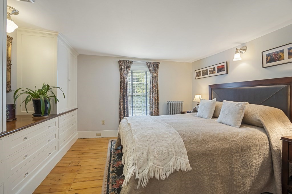 49 Parker Street Lexington, MA 02421 - Photo 27 of 42 a bedroom with a bed and a potted plant