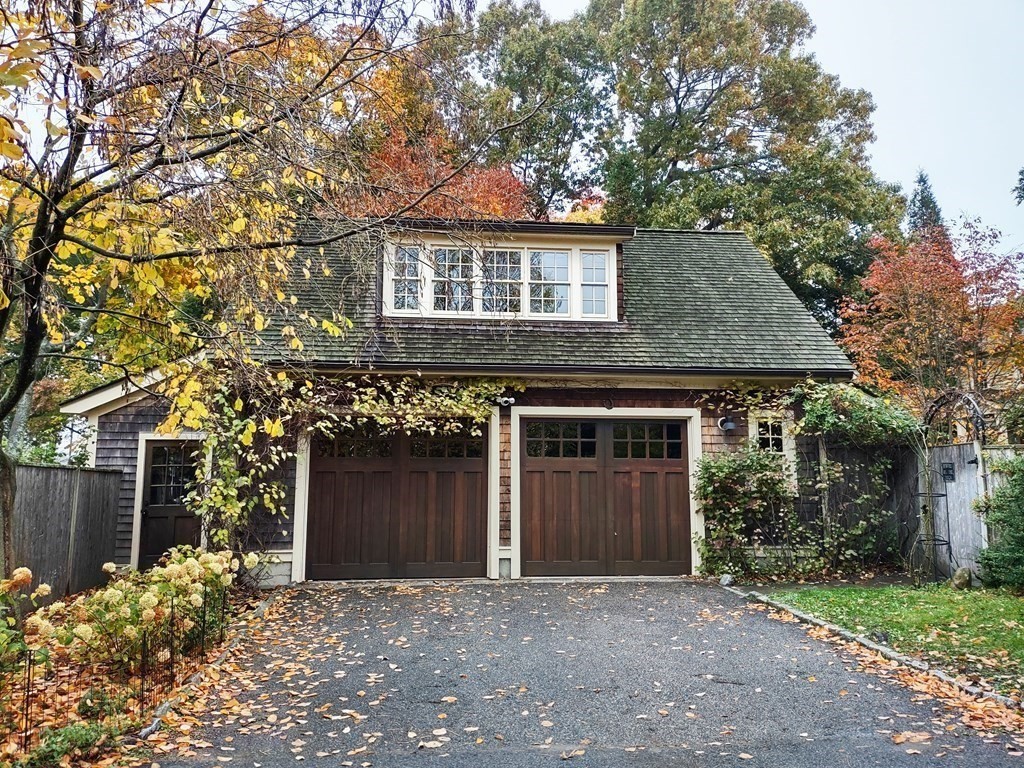 49 Parker Street Lexington, MA 02421 - Photo 39 of 42 a front view of a house with a garden and garage