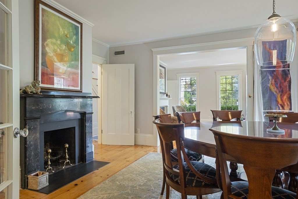 49 Parker Street Lexington, MA 02421 - Photo 6 of 42 a view of a dining room with furniture and a fireplace