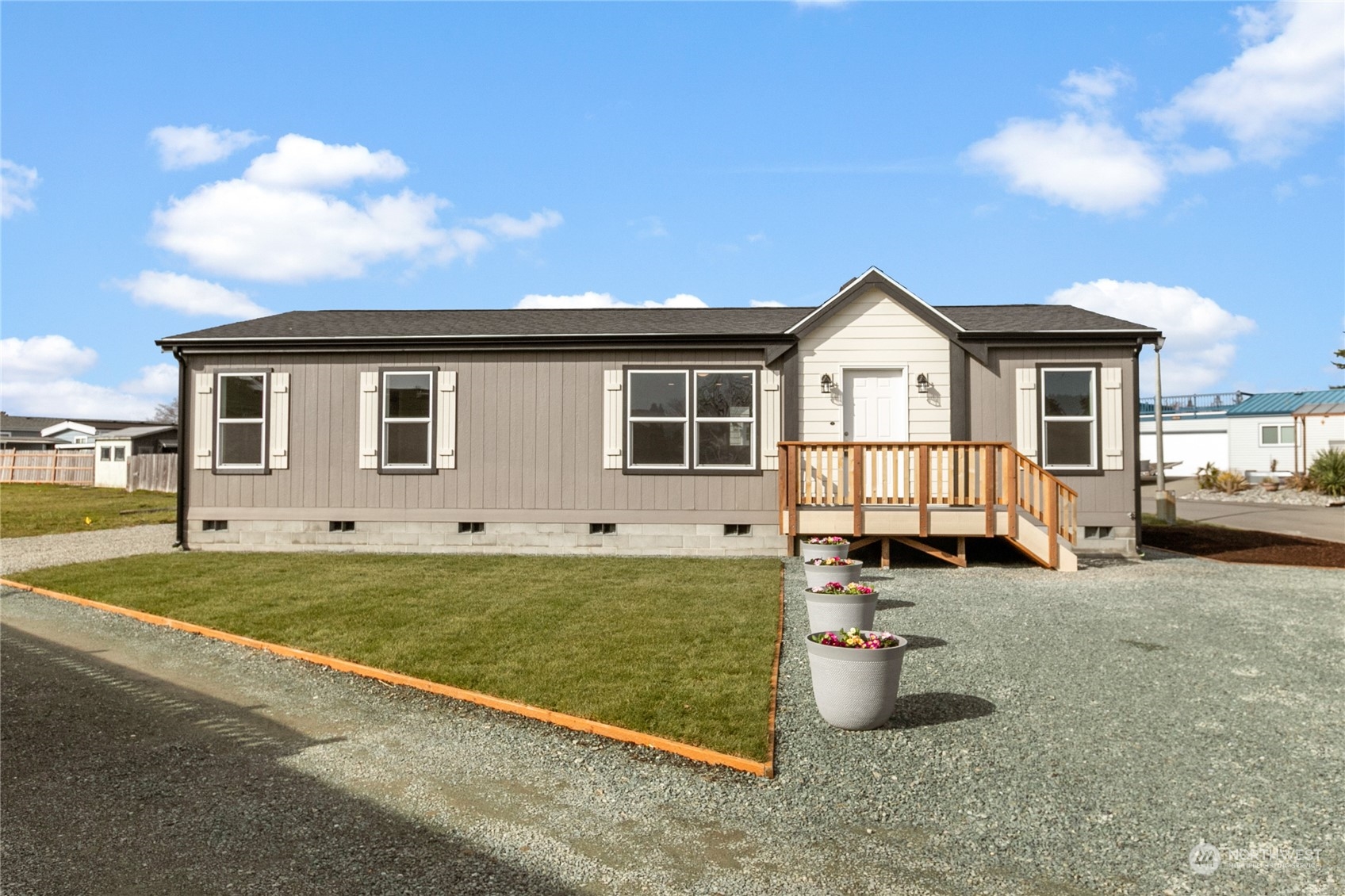 a view of a house with backyard and sitting area