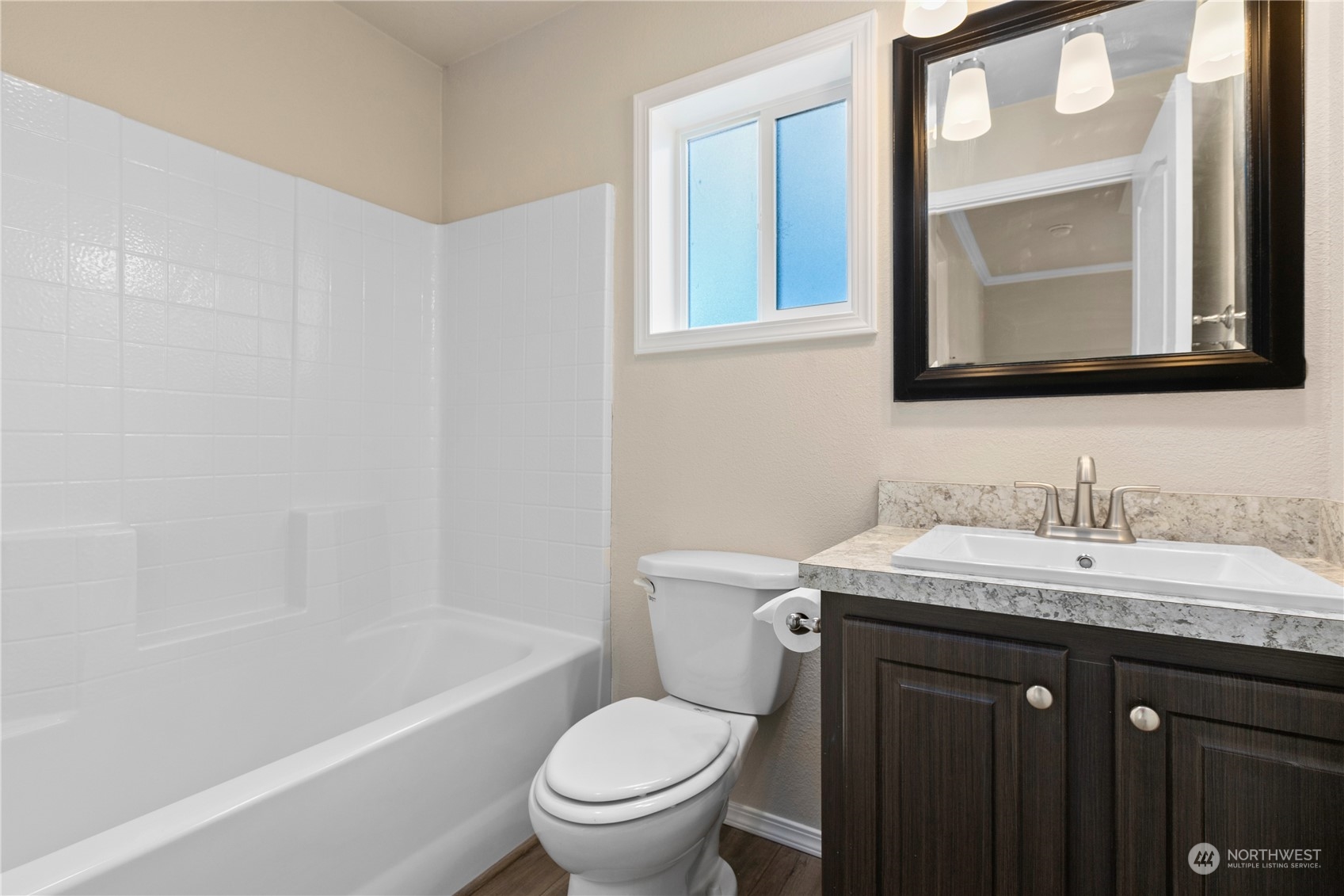 4701 Devonshire Drive Anacortes, WA 98221 - Photo 13 of 24 a bathroom with a granite countertop toilet a sink and a mirror