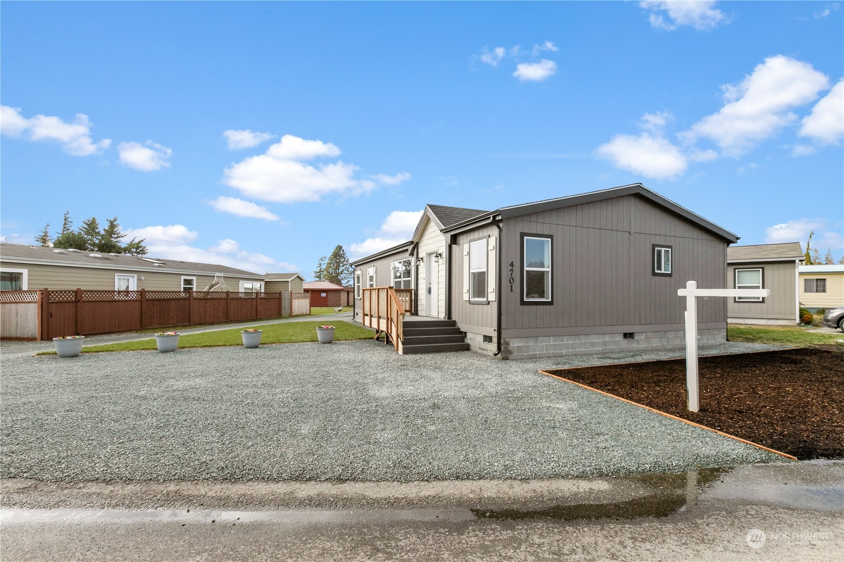 4701 Devonshire Drive Anacortes, WA 98221 - Photo 15 of 24 a view of a house with a backyard and porch