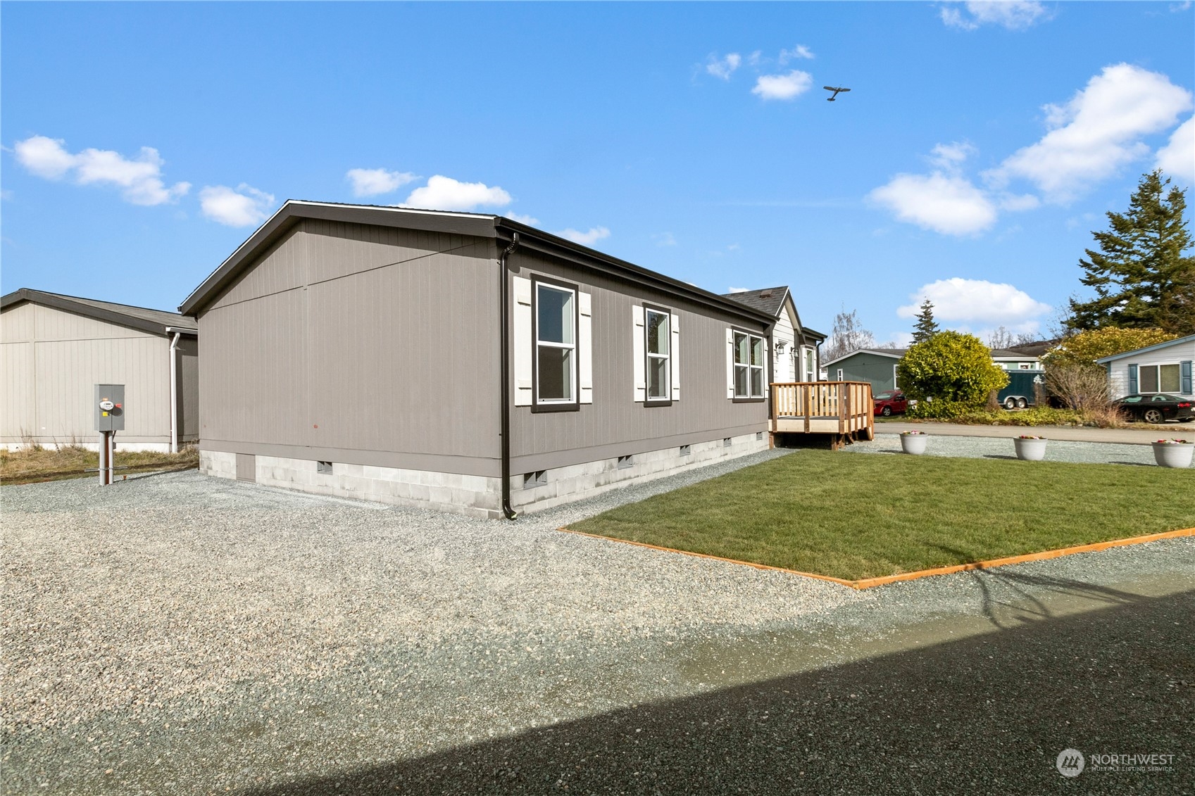 4701 Devonshire Drive Anacortes, WA 98221 - Photo 17 of 24 a view of a house with a backyard and trees