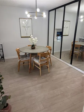 a dining room with furniture and a chandelier