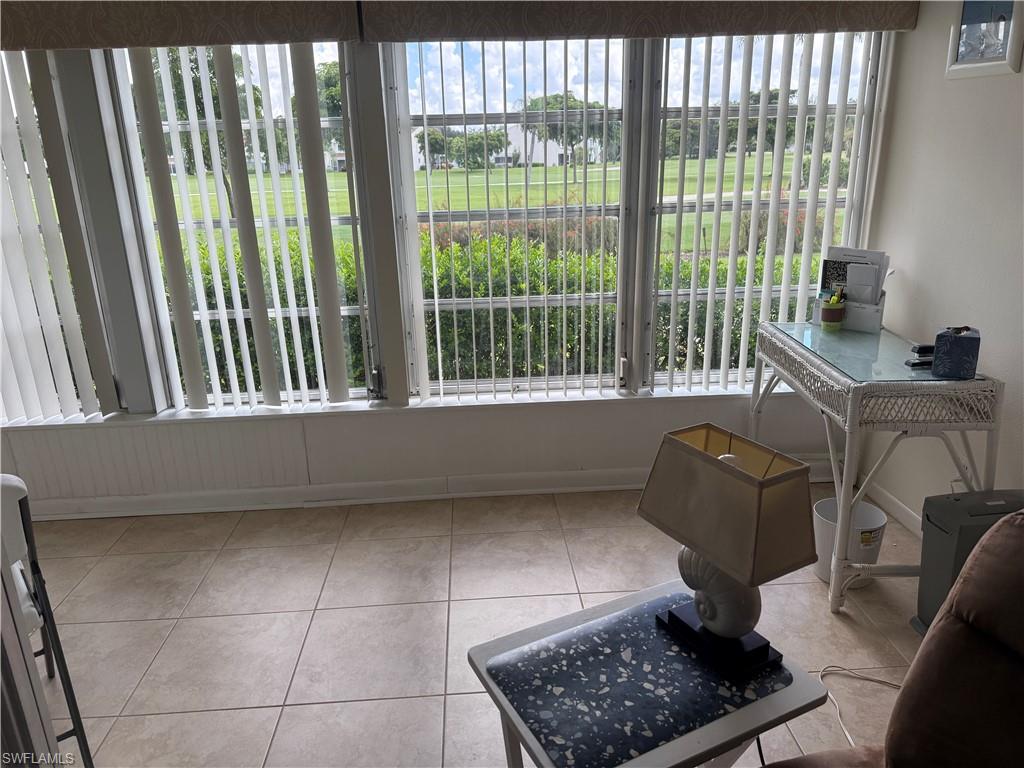 315 St Andrews Boulevard, Unit A2 Naples, FL 34113 - Photo 16 of 17 a living room with furniture and a window