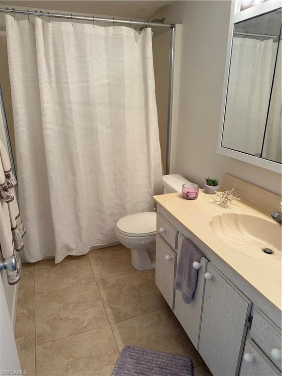 315 St Andrews Boulevard, Unit A2 Naples, FL 34113 - Photo 3 of 17 a bathroom with a sink a toilet and a mirror