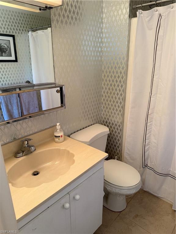 315 St Andrews Boulevard, Unit A2 Naples, FL 34113 - Photo 7 of 17 a bathroom with a sink a toilet and shower
