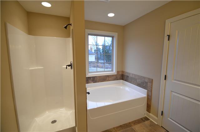 120 Legends Ridge Drive, Unit 26 Lebanon, TN 37090 - Photo 12 of 18 Master bath with separate shower and garden tub with tile backsplash