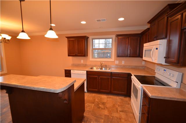 120 Legends Ridge Drive, Unit 26 Lebanon, TN 37090 - Photo 6 of 18 Kitchen with custom cabinets,tile flooring and bar overlooking Great Room