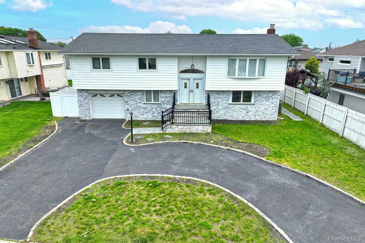 107 Beverly Road Massapequa, NY 11758 - Photo 35 of 41 a view of a house with a swimming pool