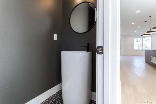 a bathroom with a toilet and a mirror