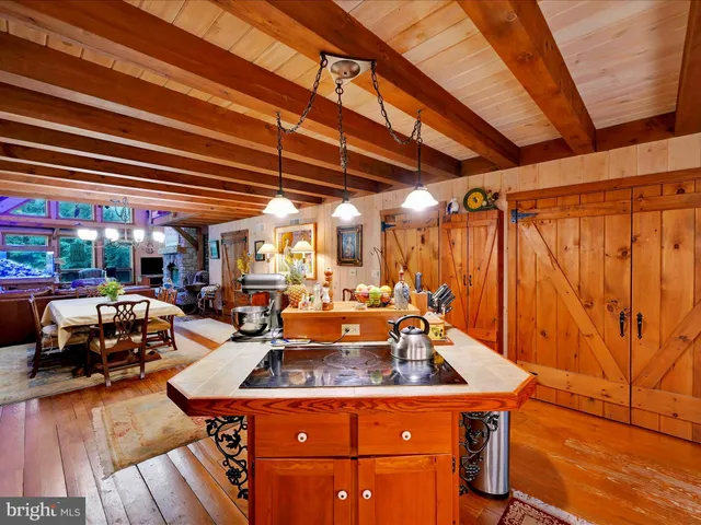 a bedroom with a bed next to a window with the dresser
