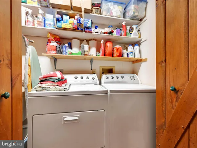 a bedroom with bed and large windows
