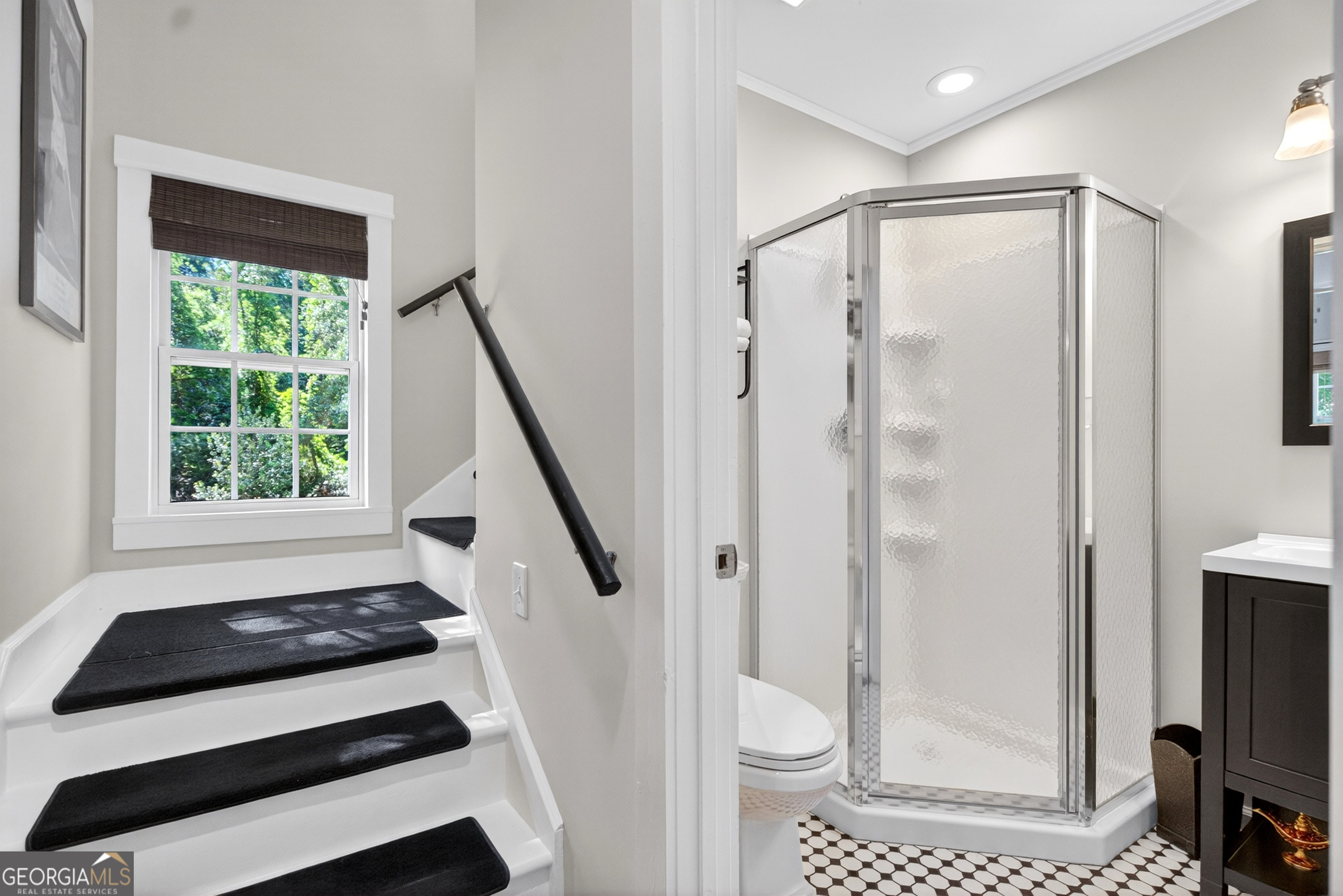 4656 Greenville Road LaGrange, GA 30241 - Photo 18 of 34 a bathroom with a shower a sink a toilet a mirror and a glass door shower