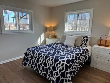 a bedroom with a bed and window