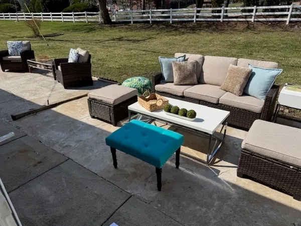 a view of a lake with couches and lounge chairs