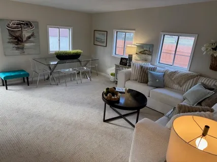 a living room with furniture a flat screen tv and a fireplace