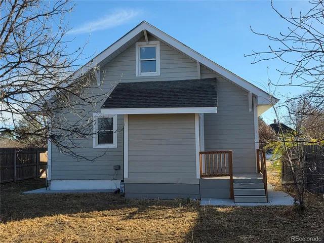 a front view of a house with wooden fence